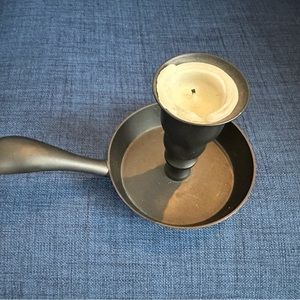 black candlestick with a holder.